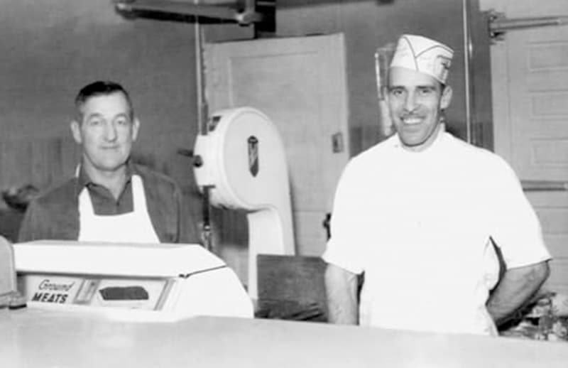 A black and white photo of Keith Jennings and his son Jason Jennings in the original meat shop.